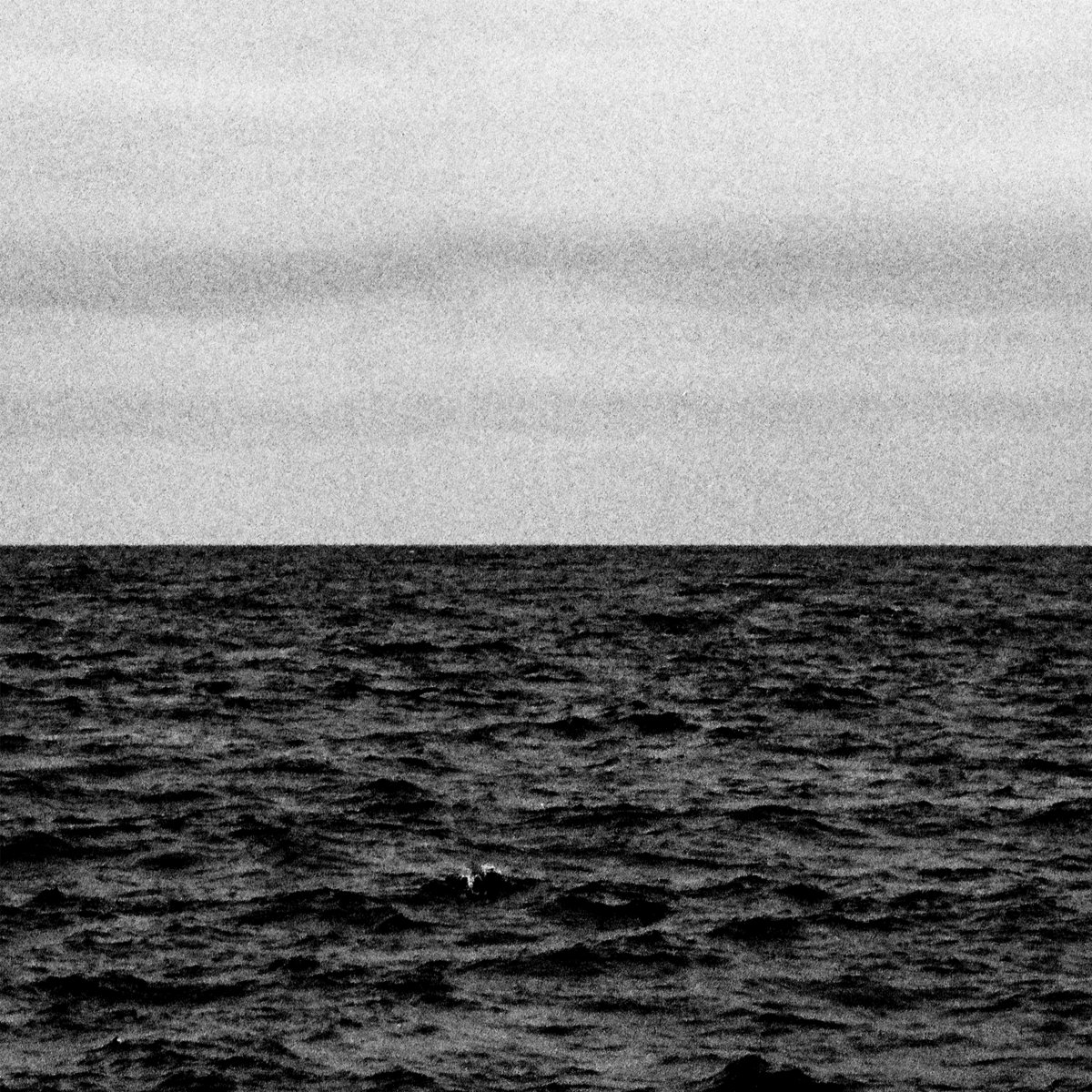 Cover art for Cloudmirror by Lost Air. Black and white image of an unending horizon with clouded sky above and choppy ocean waters below.